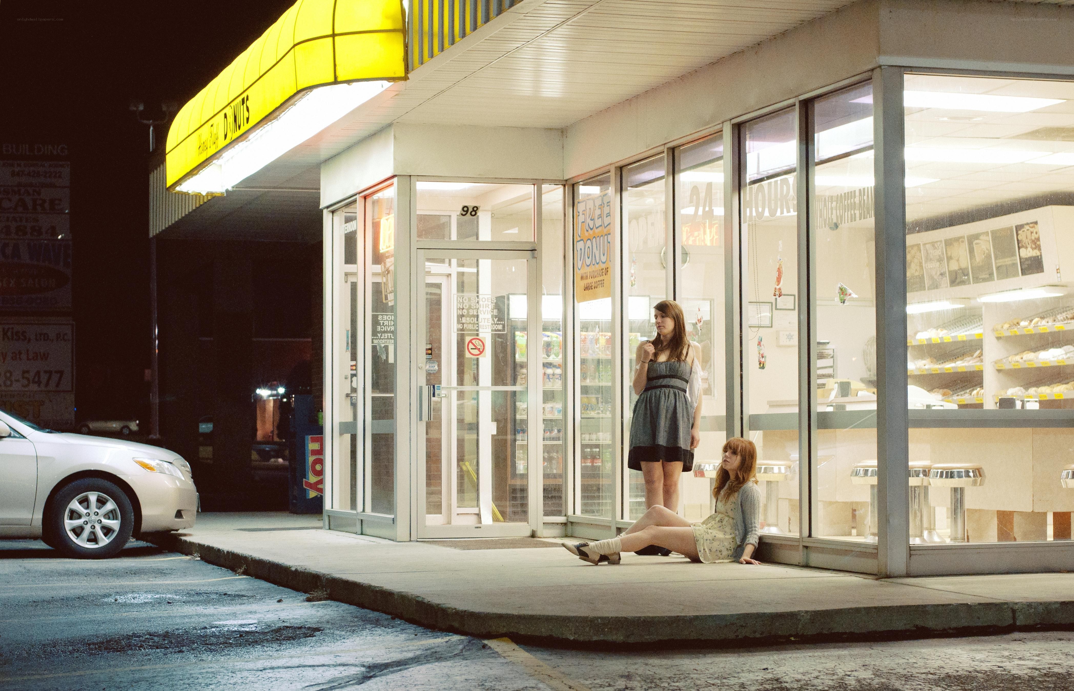 Two women outside a donut shop