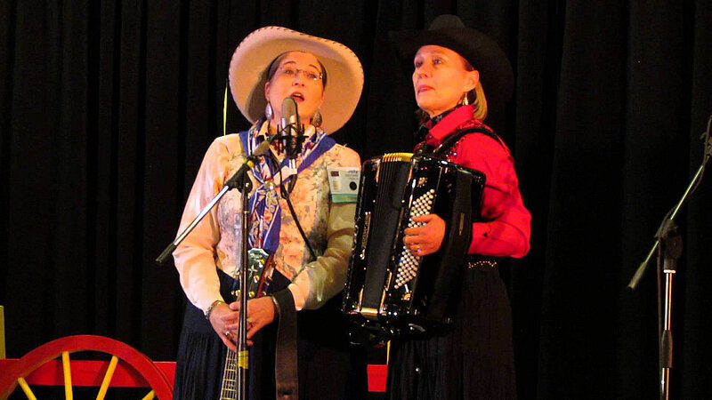 Two Women Performing on Stage — Black