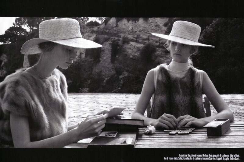 Two women playing cards outdoors