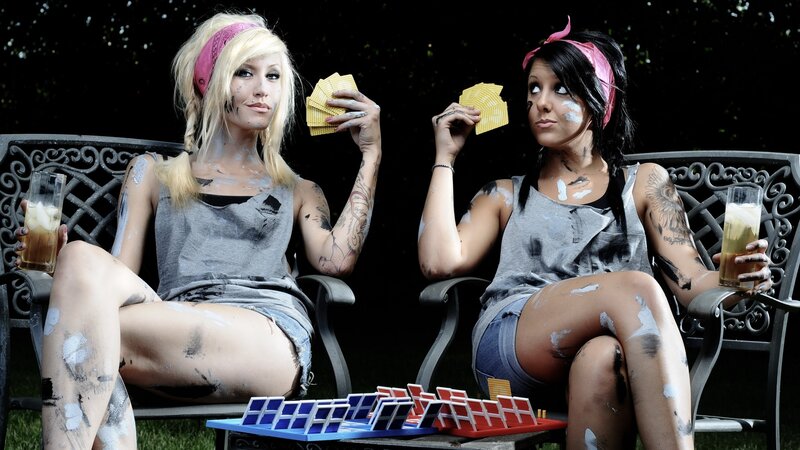 Two women playing cards outdoors