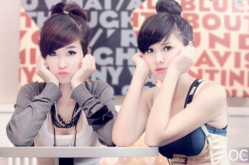 two women posing at a table