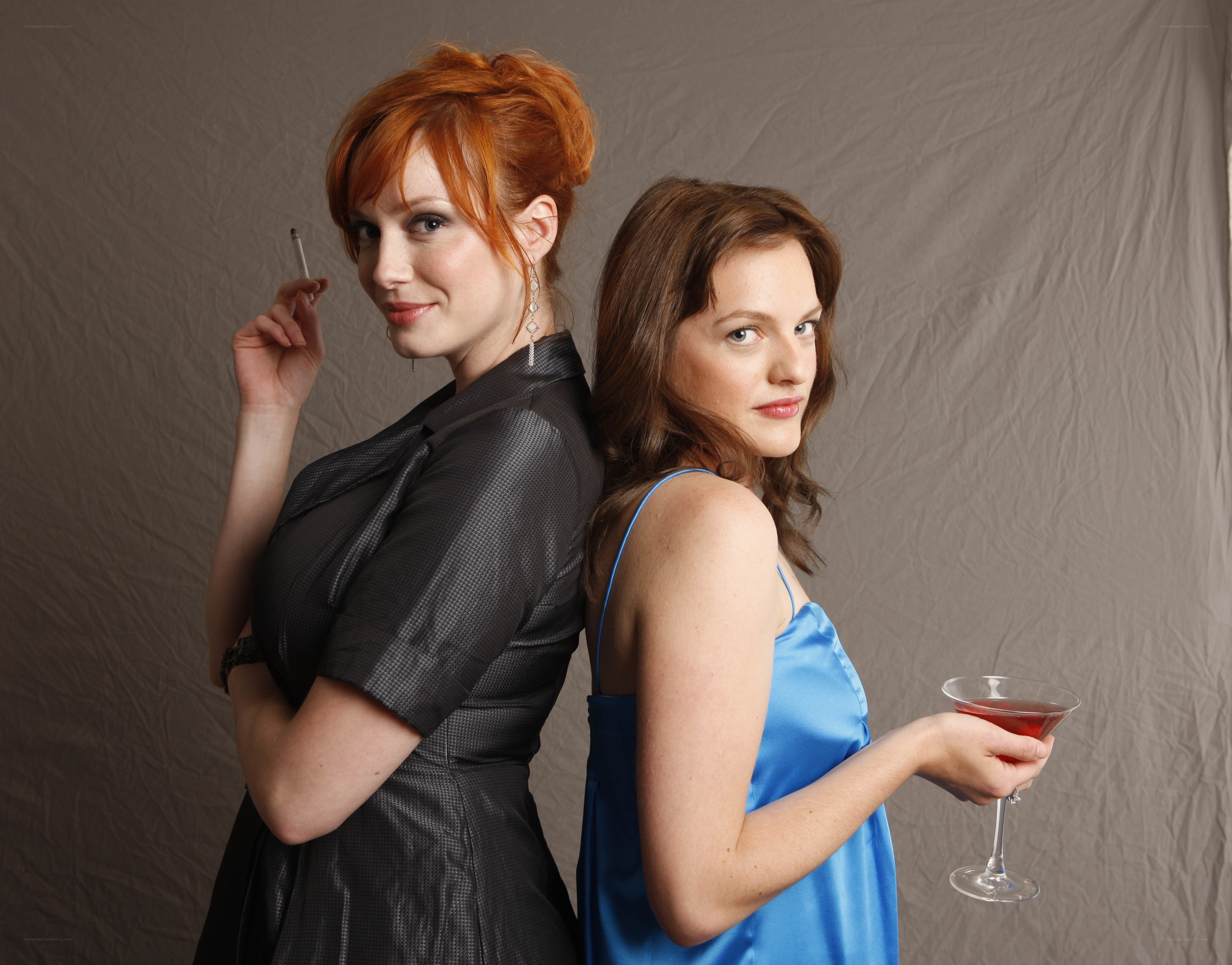 Two women posing back to back