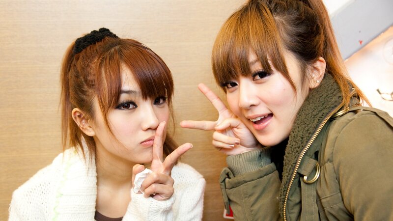 two women posing for camera