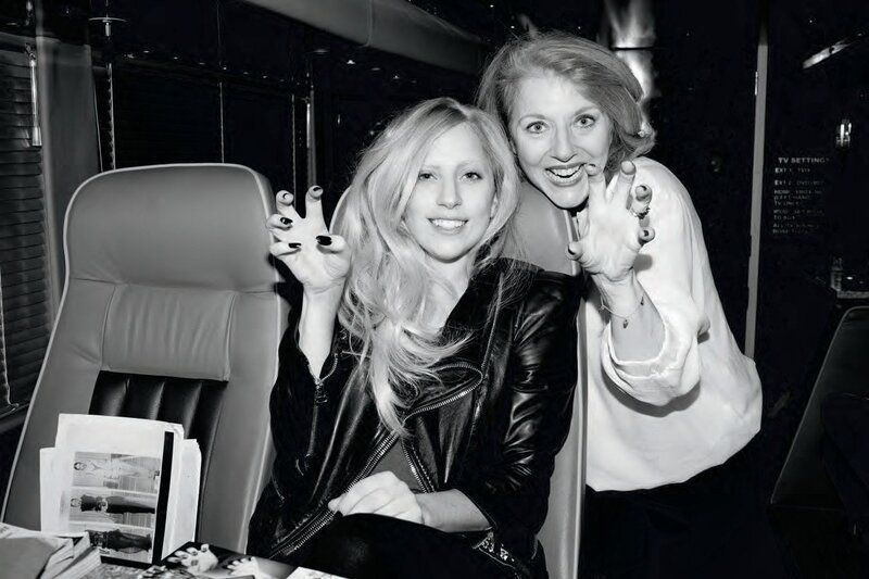 Two women posing in a vehicle