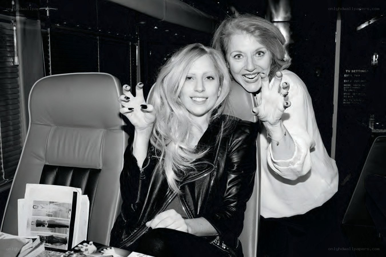 Two women posing in a vehicle