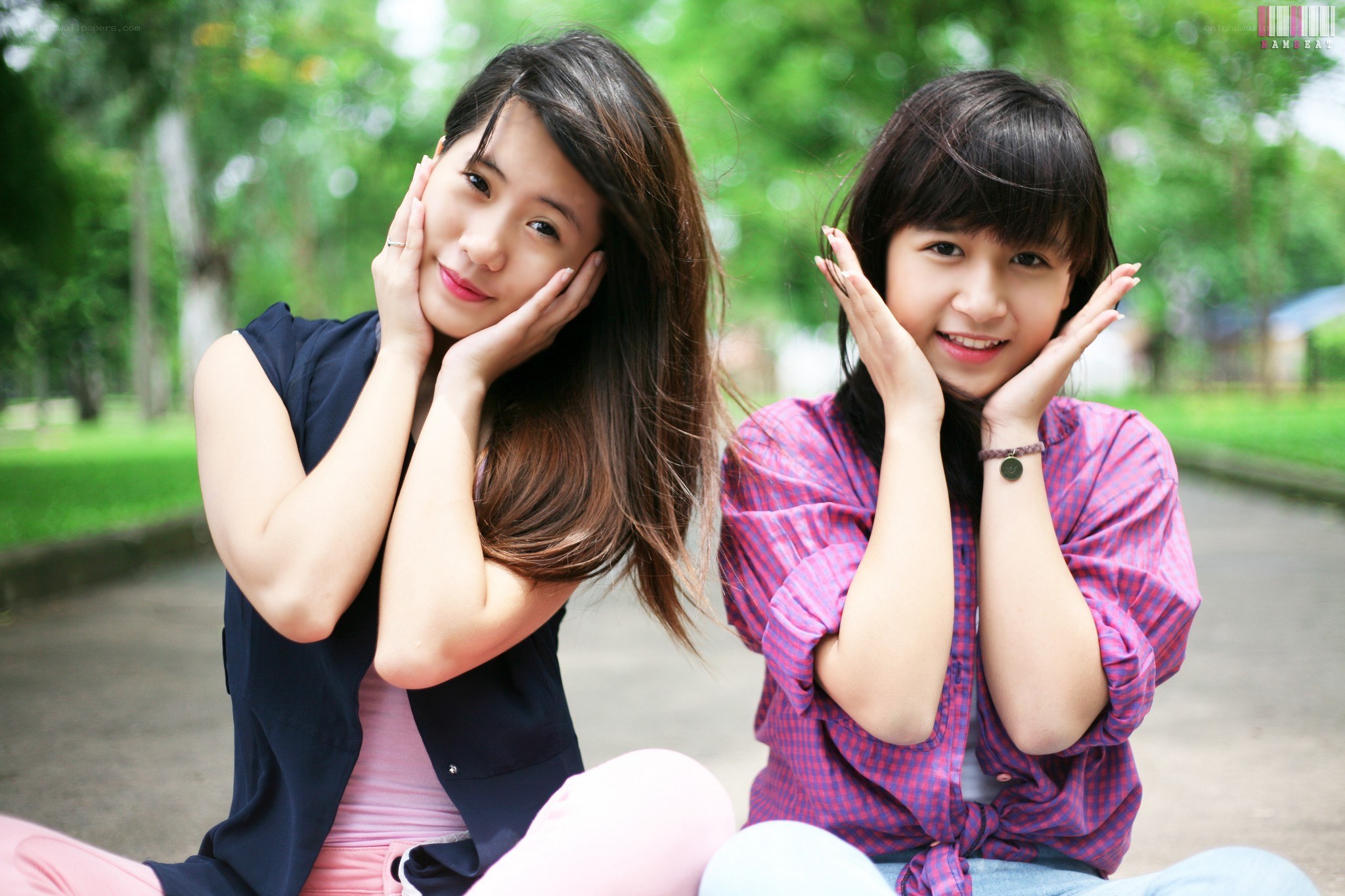 two women posing in park