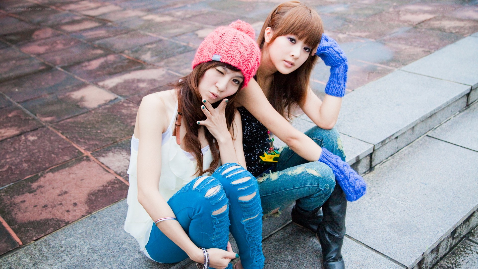 Two women posing on steps