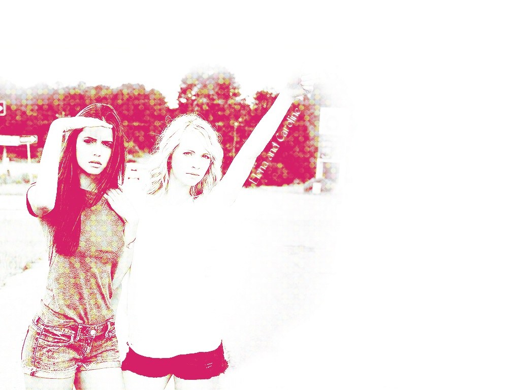 two women posing outdoors