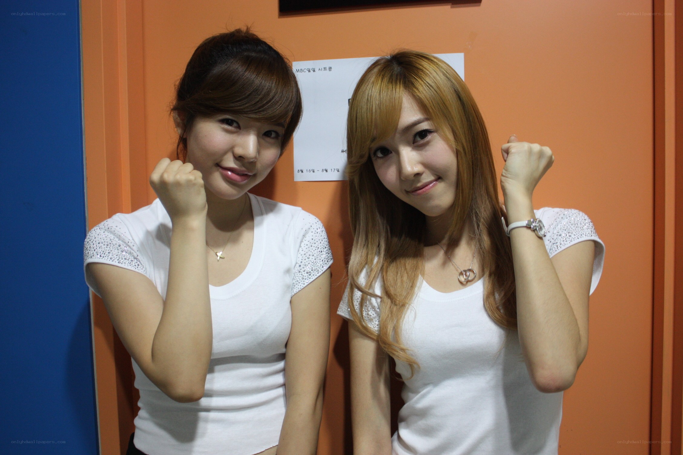 two women posing with fists