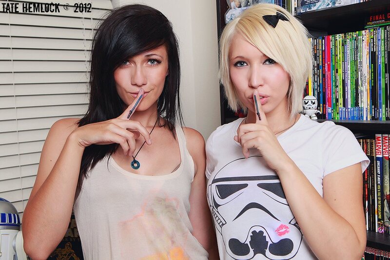 Two women posing with pens