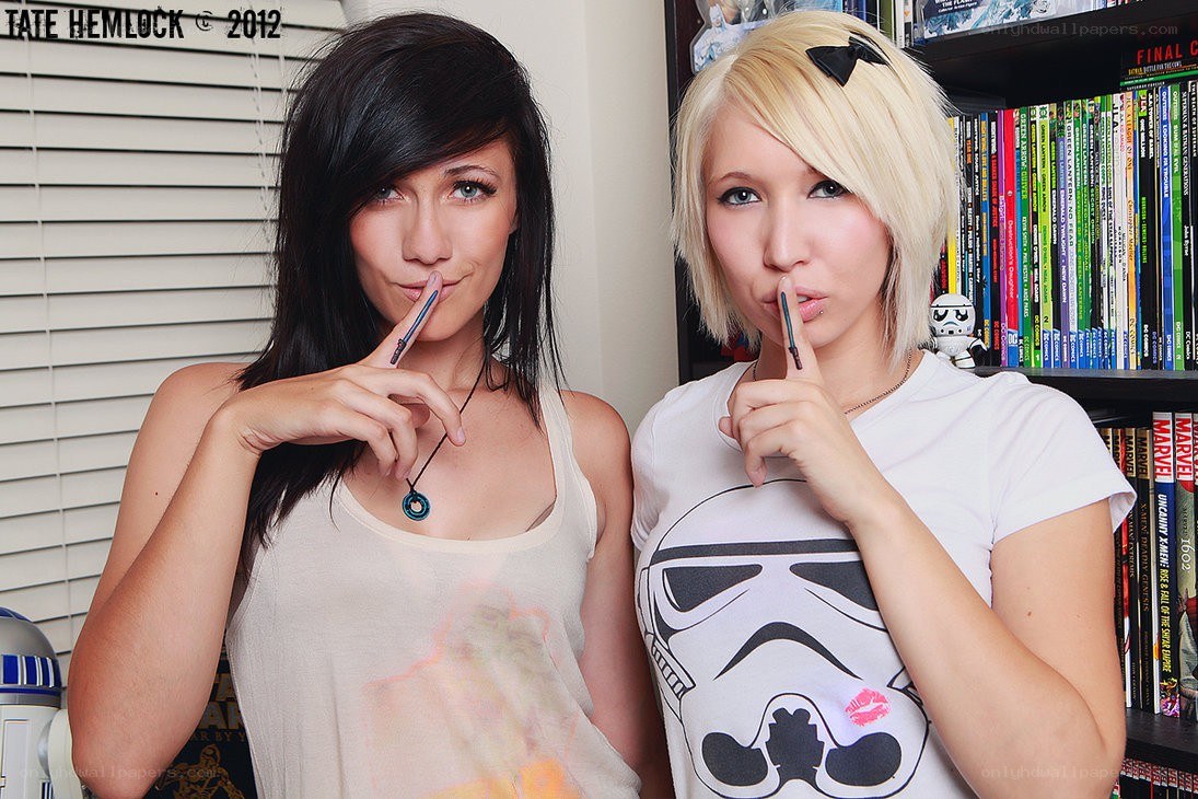 Two women posing with pens