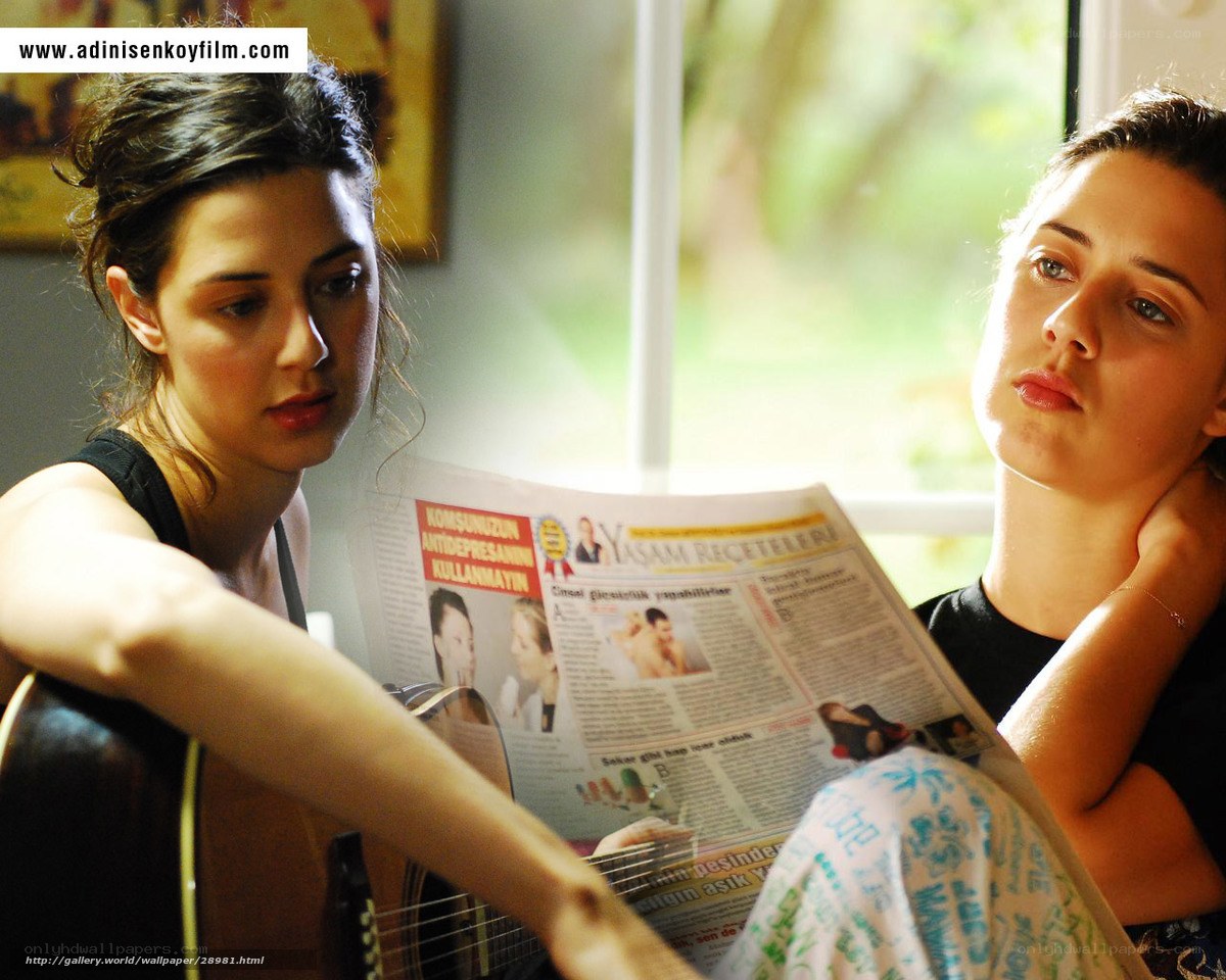 Two women reading a newspaper
