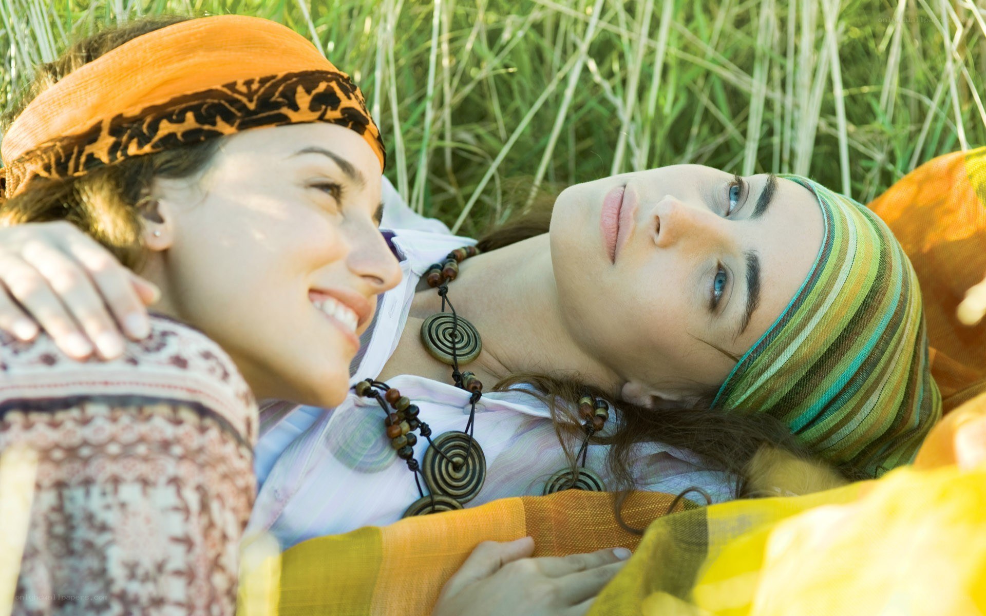 Two women relaxing in grass