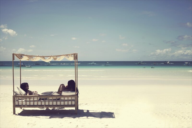 Two women relaxing on a beach