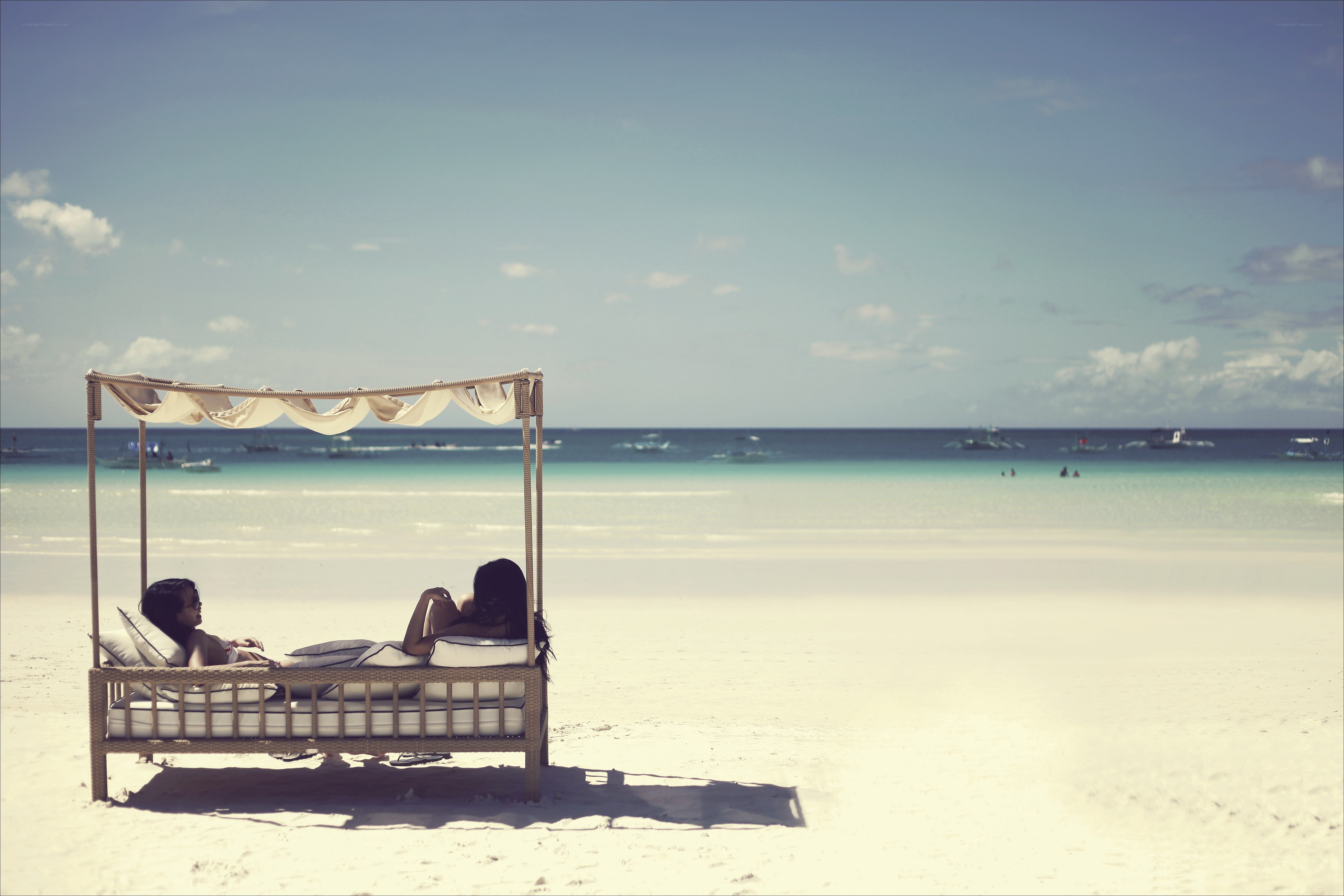 Two women relaxing on a beach
