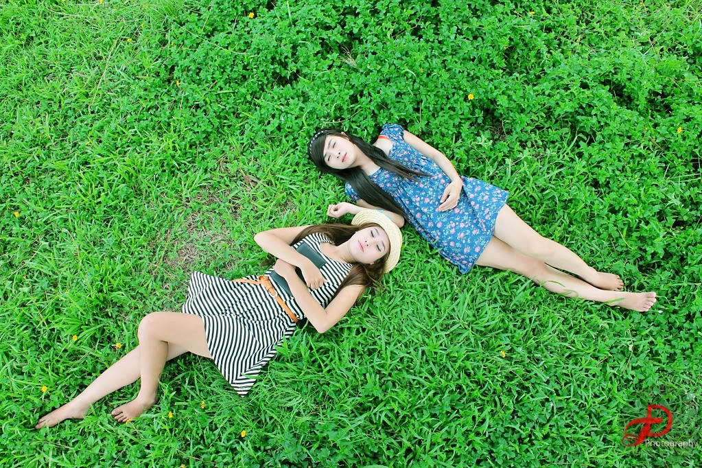 Two women relaxing on grass