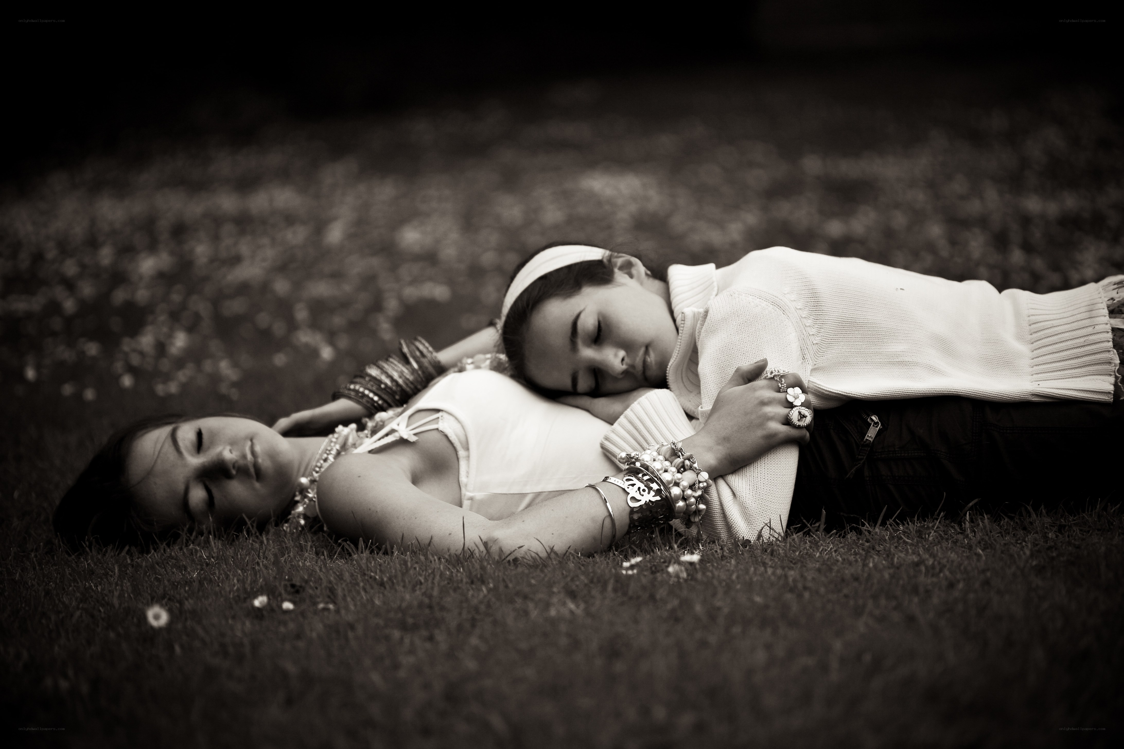 Two women resting on grass