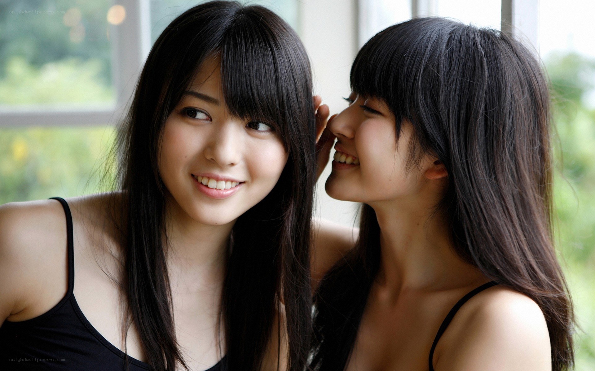 two women sharing a secret