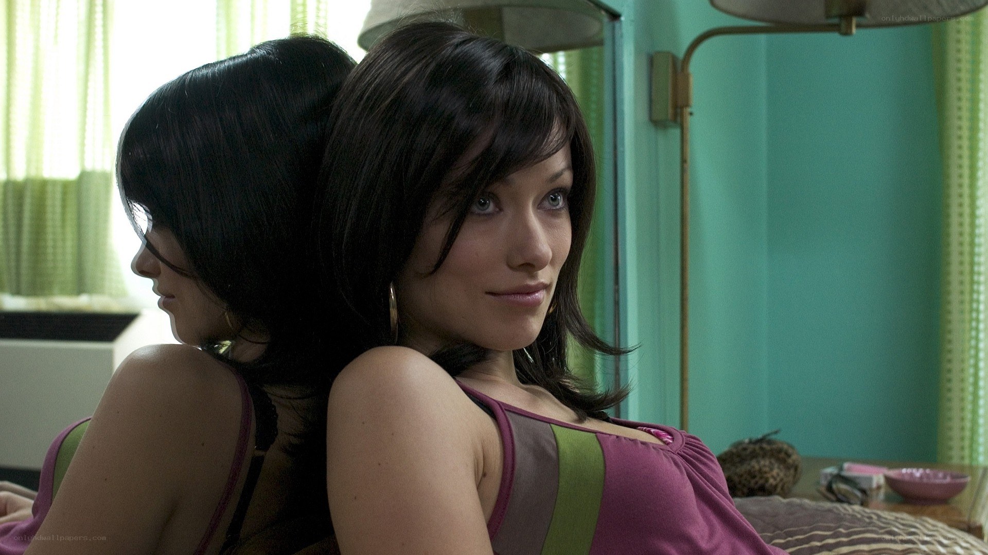 two women sitting back to back