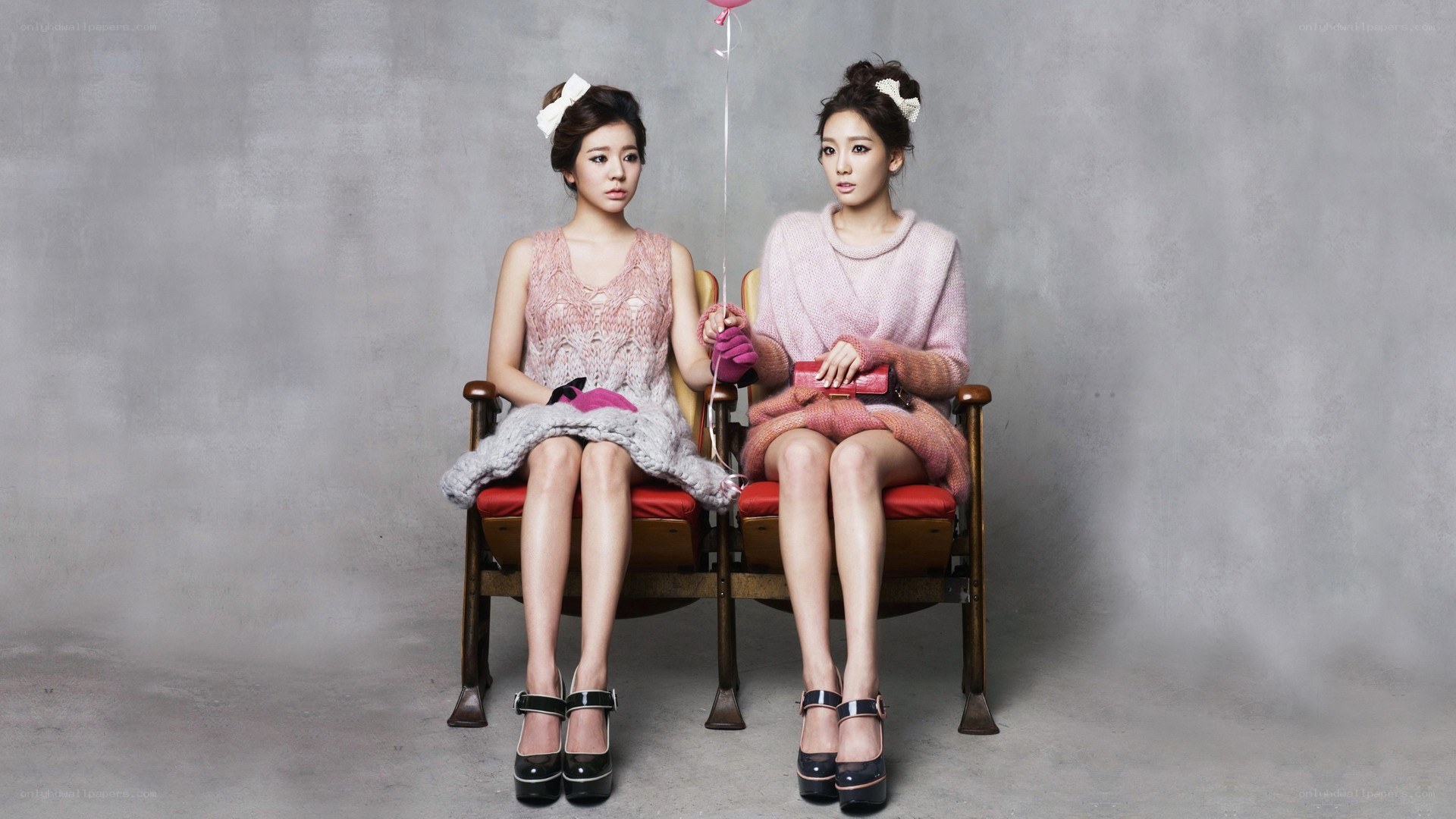 two women sitting on a bench