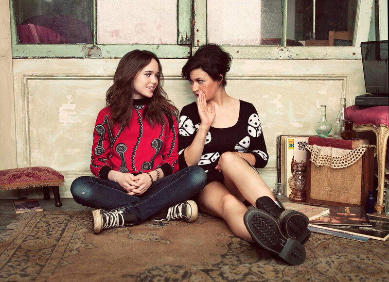 Two women sitting on a rug
