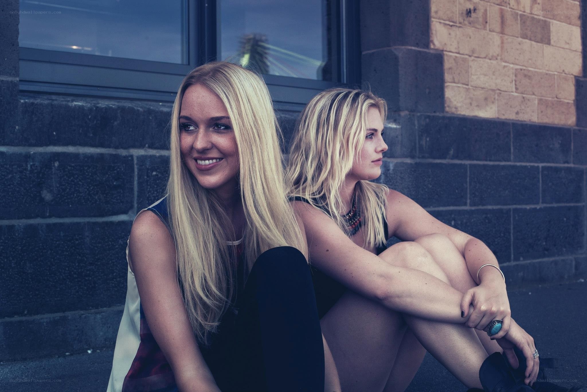 Two women sitting on a step