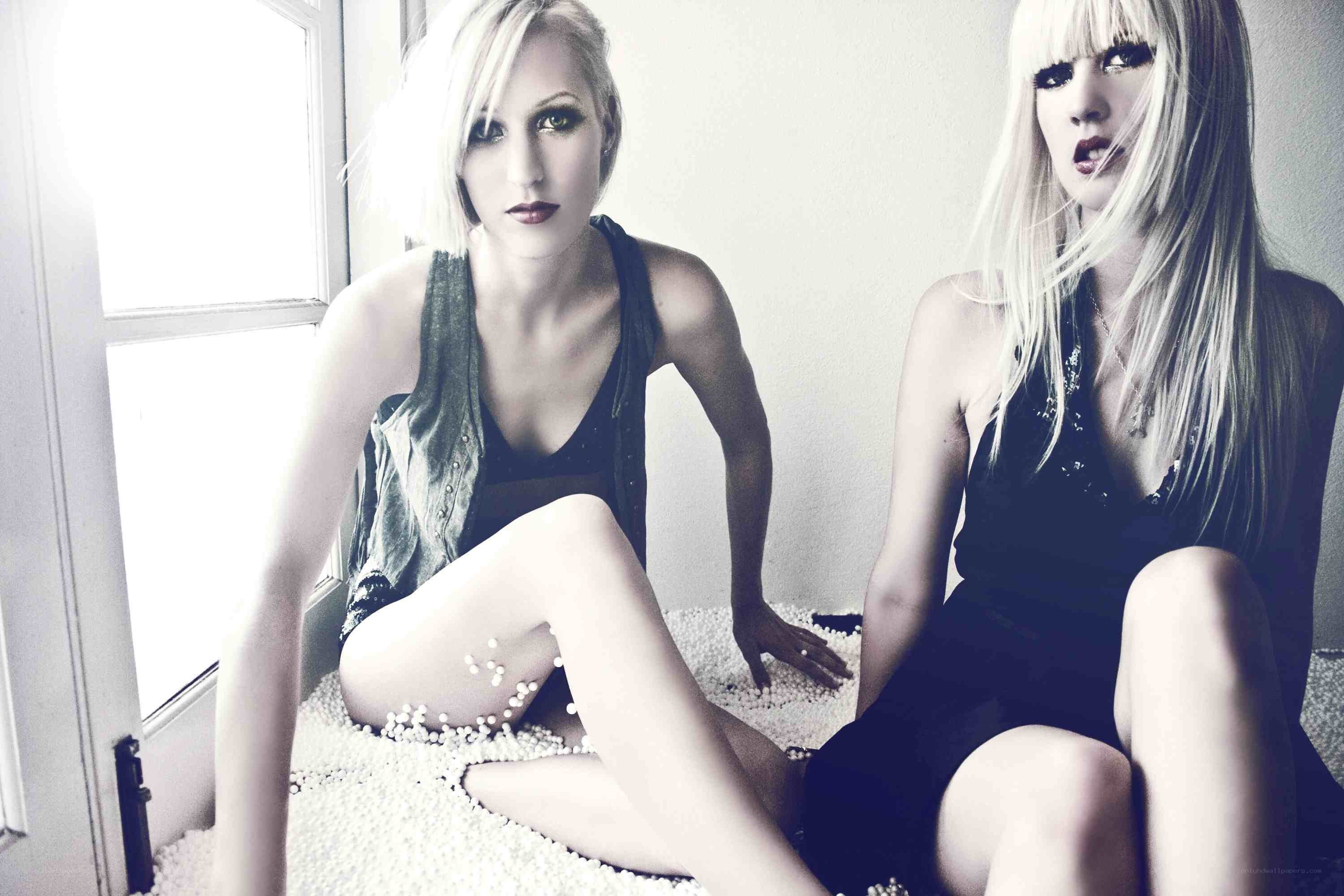two women sitting on beads