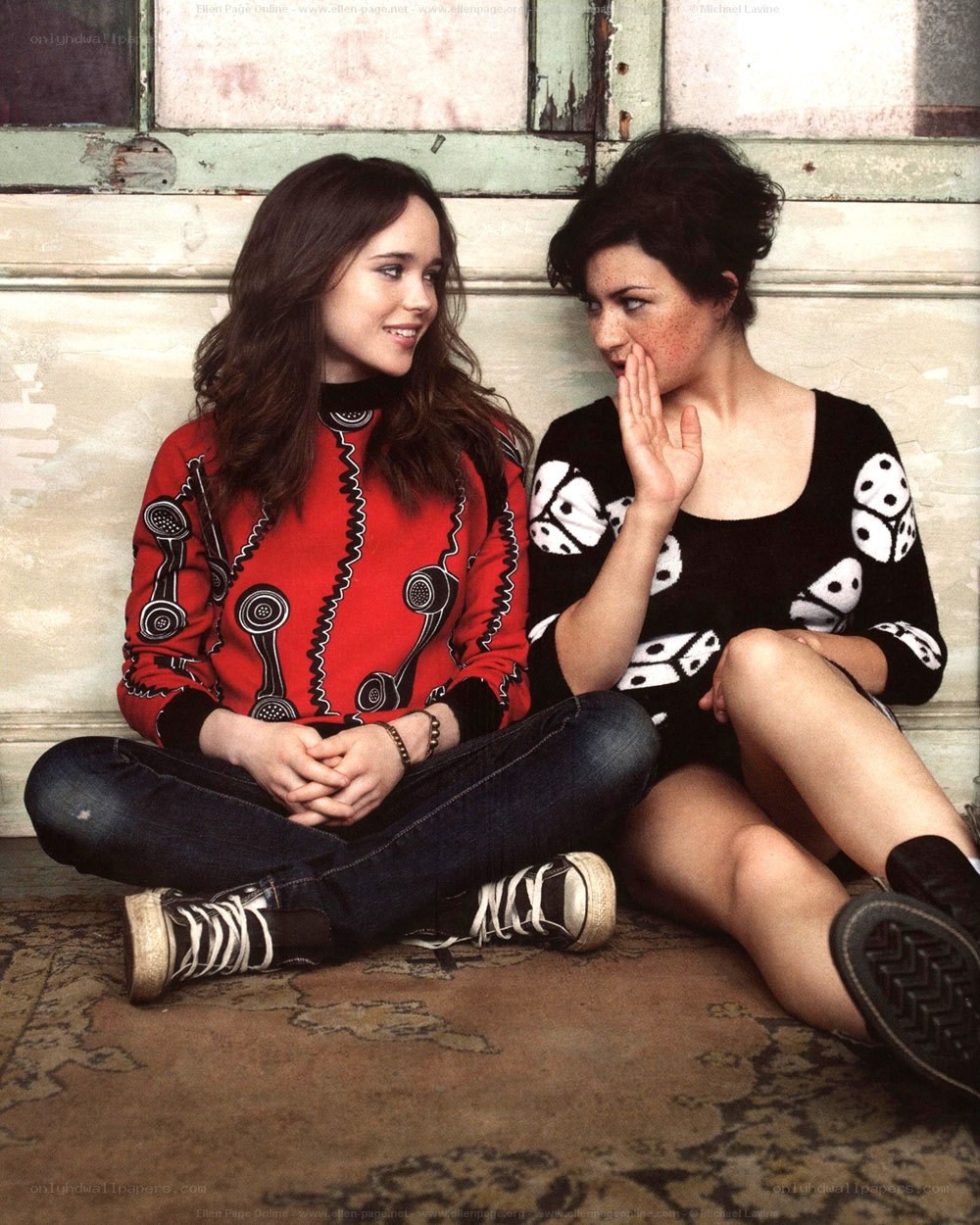 Two women sitting on floor