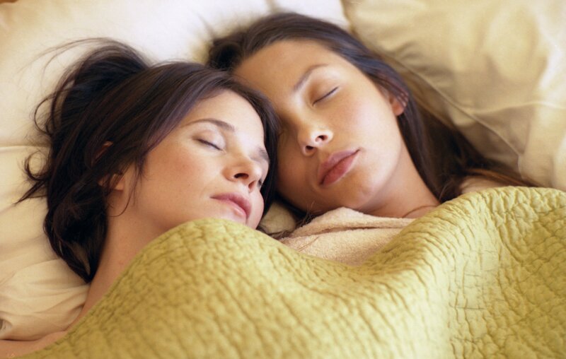 Two women sleeping together