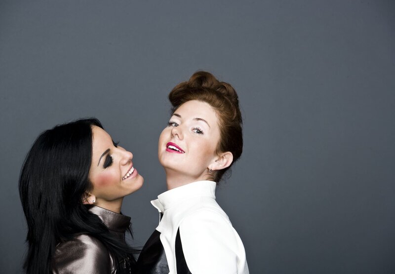 two women smiling at each other