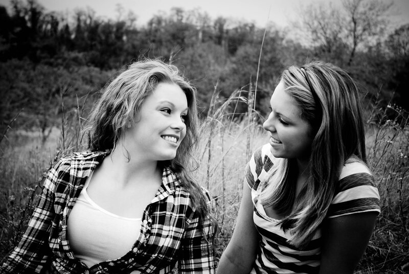 two women smiling in a field