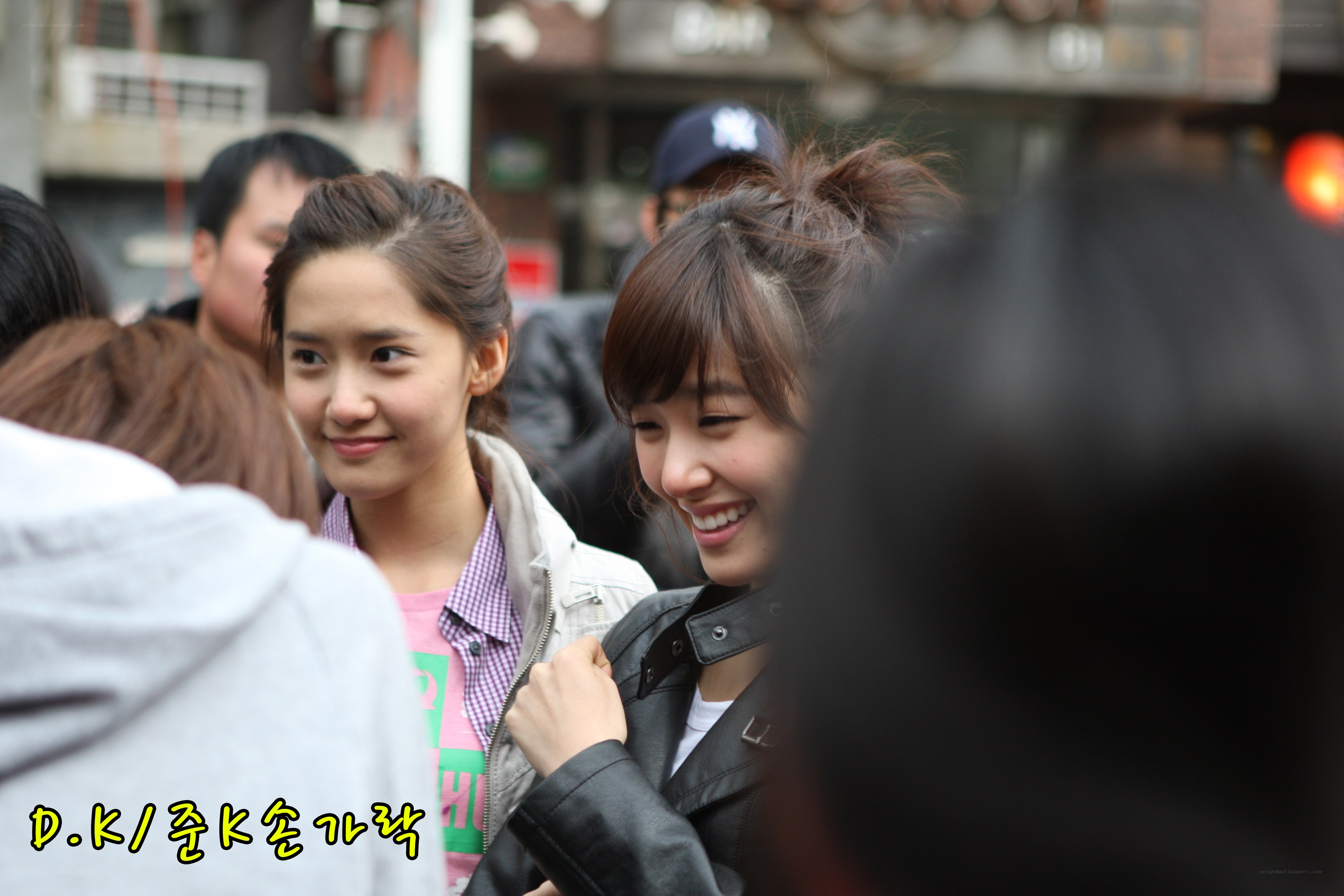 two women smiling in crowd