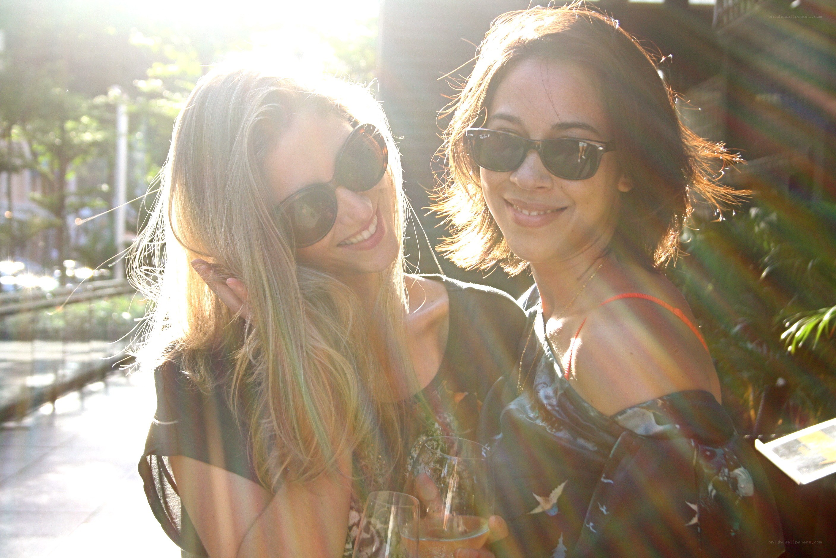 Two women smiling in sunlight