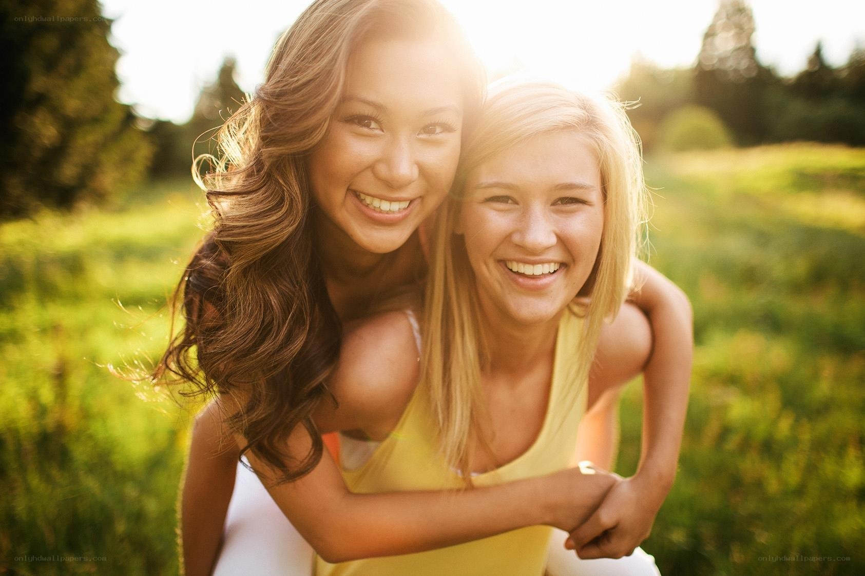 two women smiling outdoors