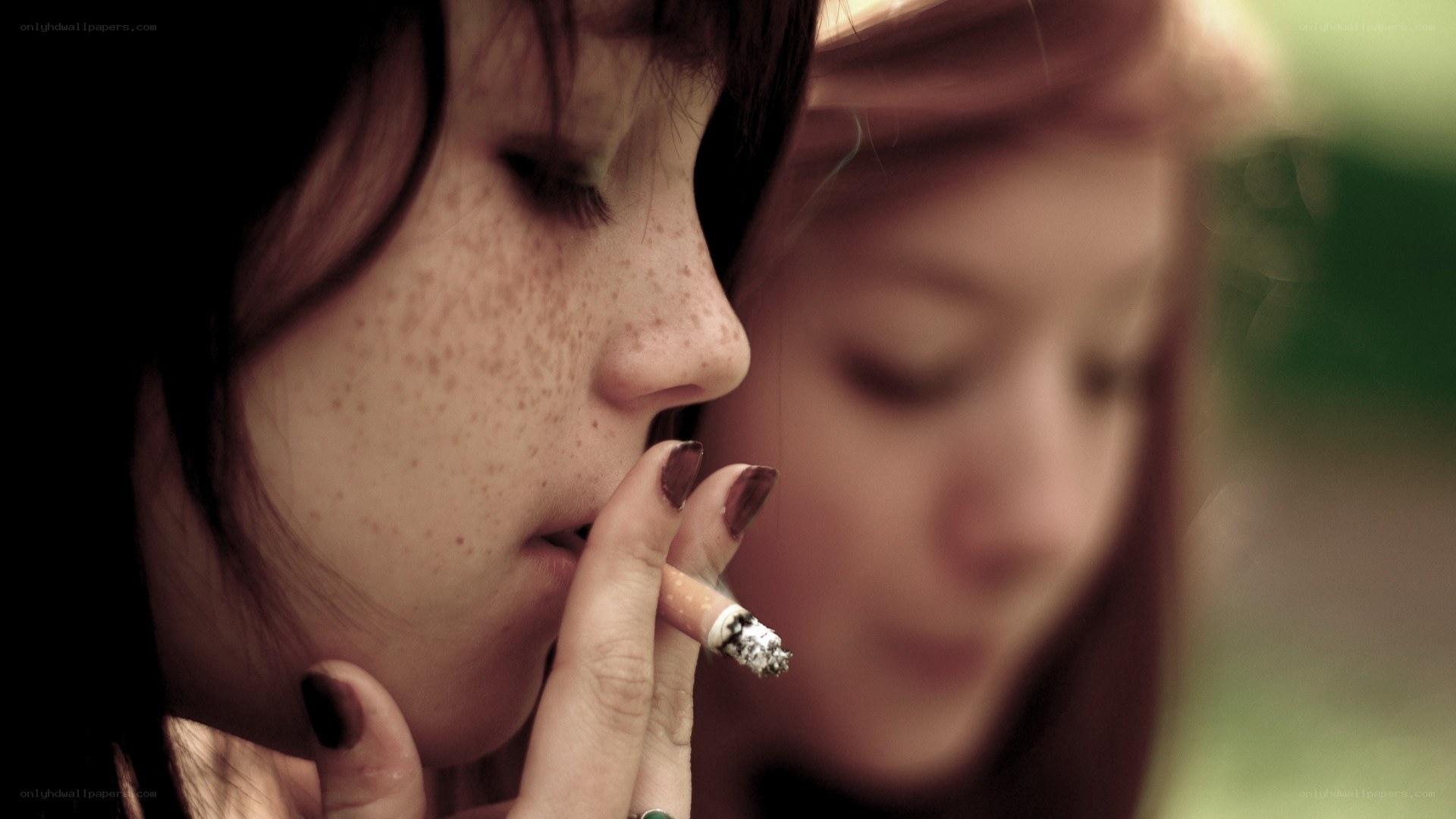 two women smoking together