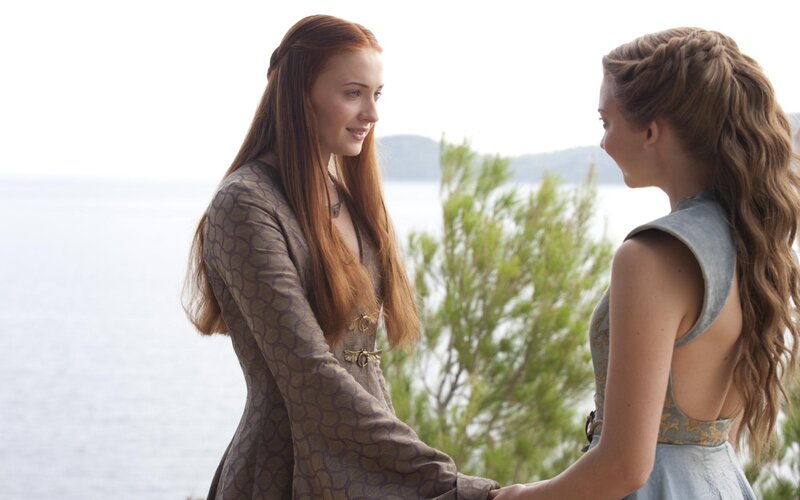Two women talking by the sea