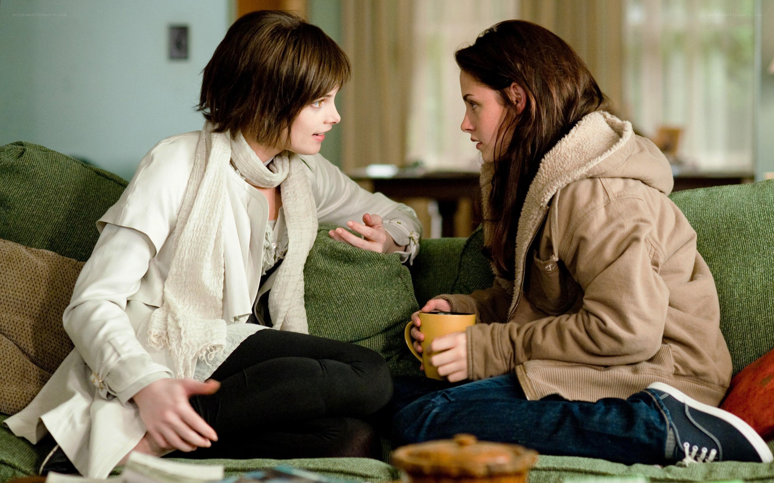 two women talking on a couch
