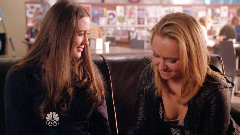 two women talking on a couch