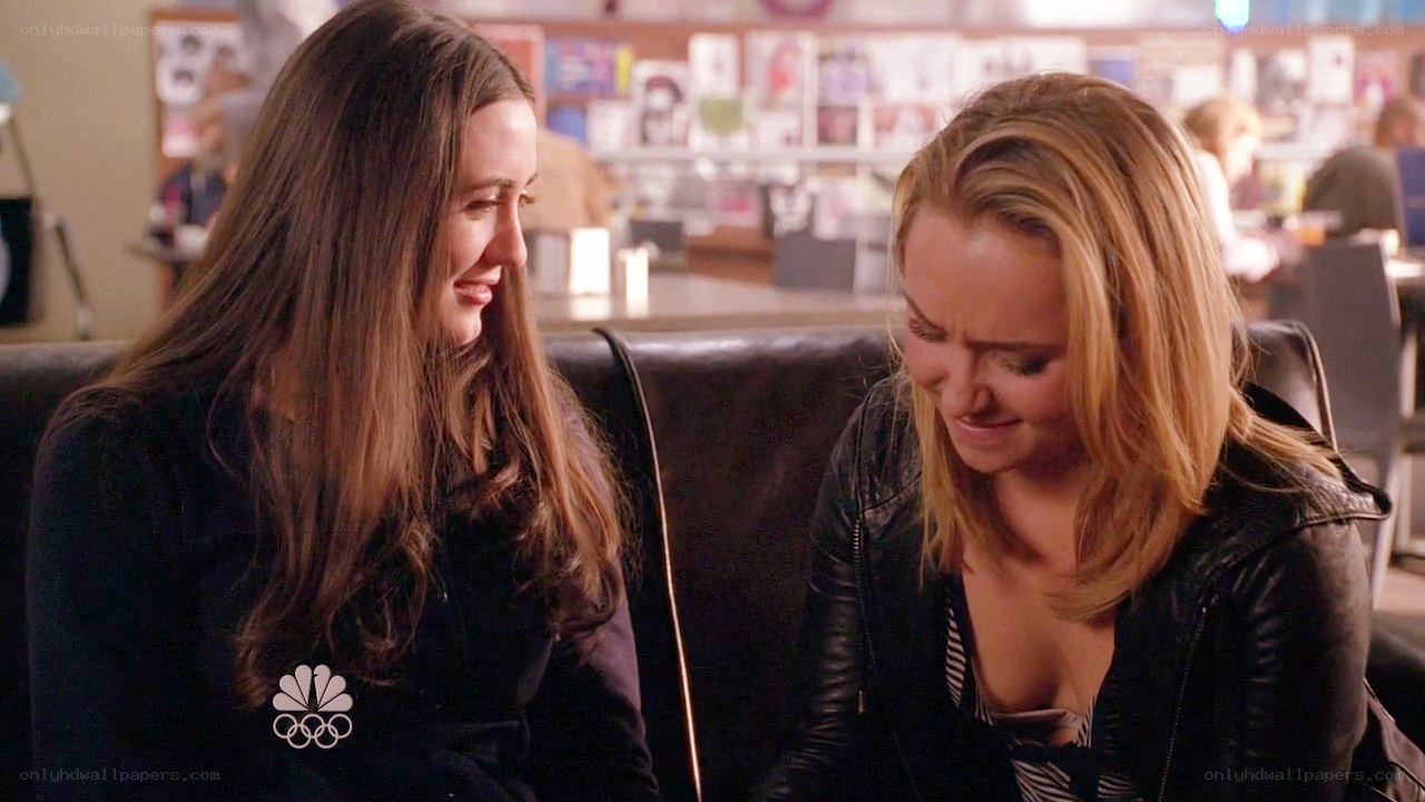 two women talking on a couch