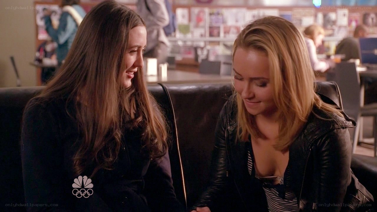 two women talking on a couch