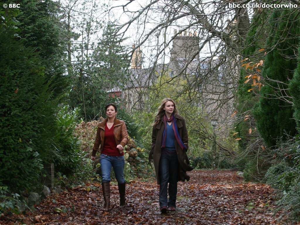 two women walking in a garden