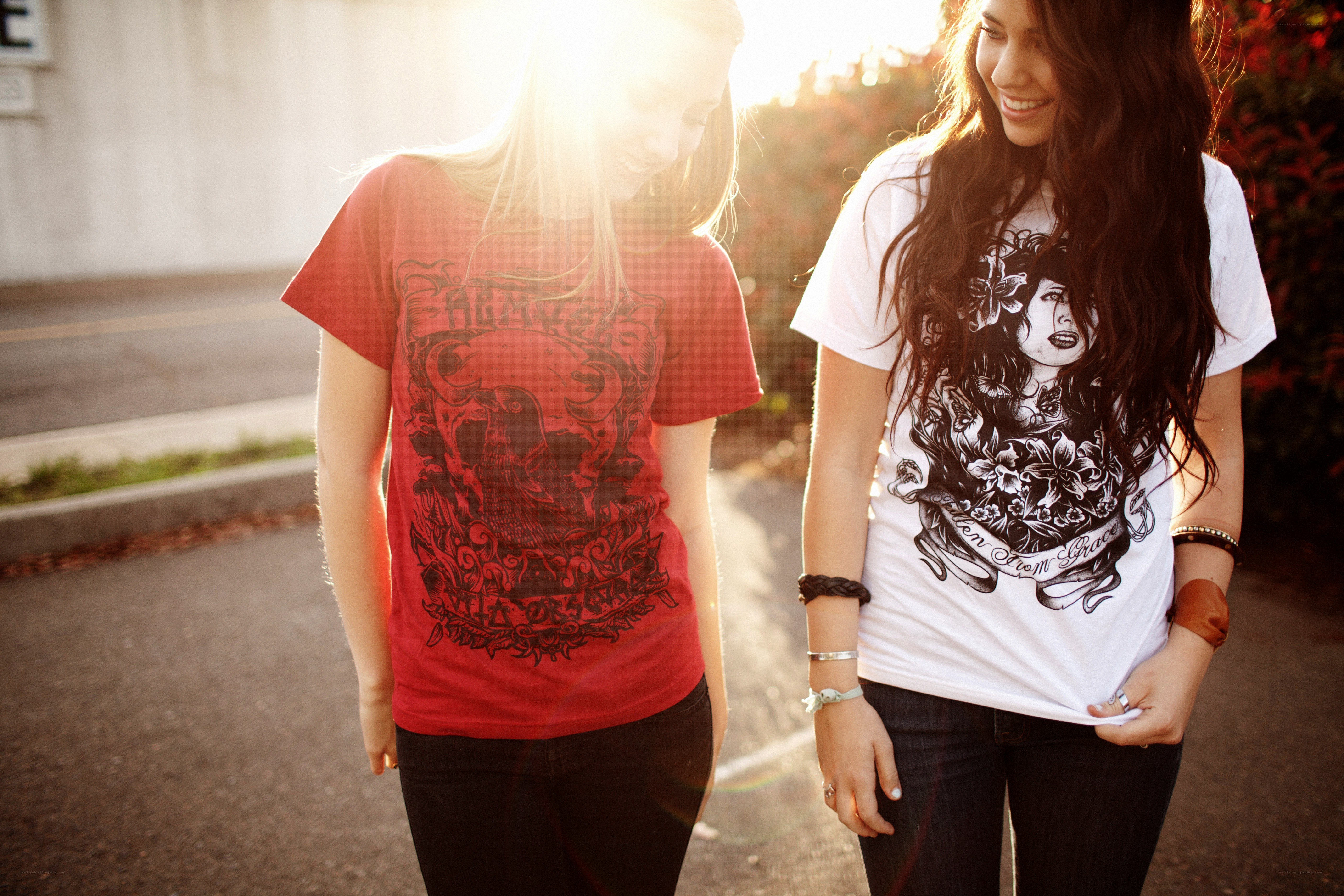 two women walking in sunlight