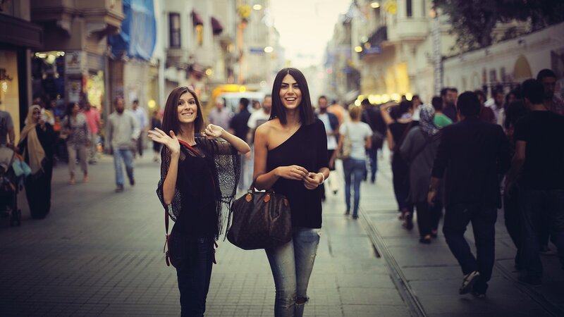 Two women walking on a city street