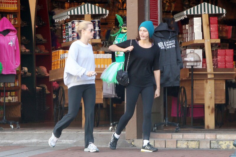Two women walking on a street