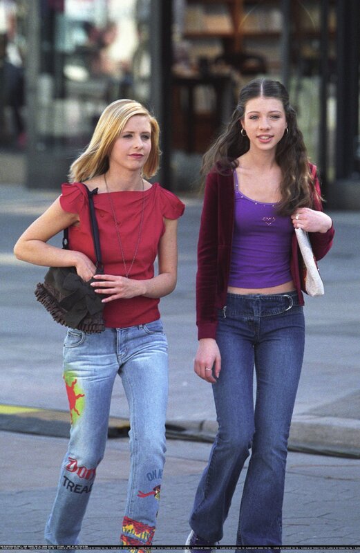 Two women walking on a street
