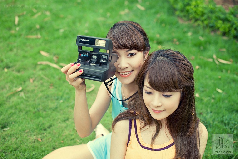 Two women with a polaroid camera