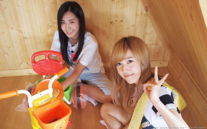 Two women with a toy bike