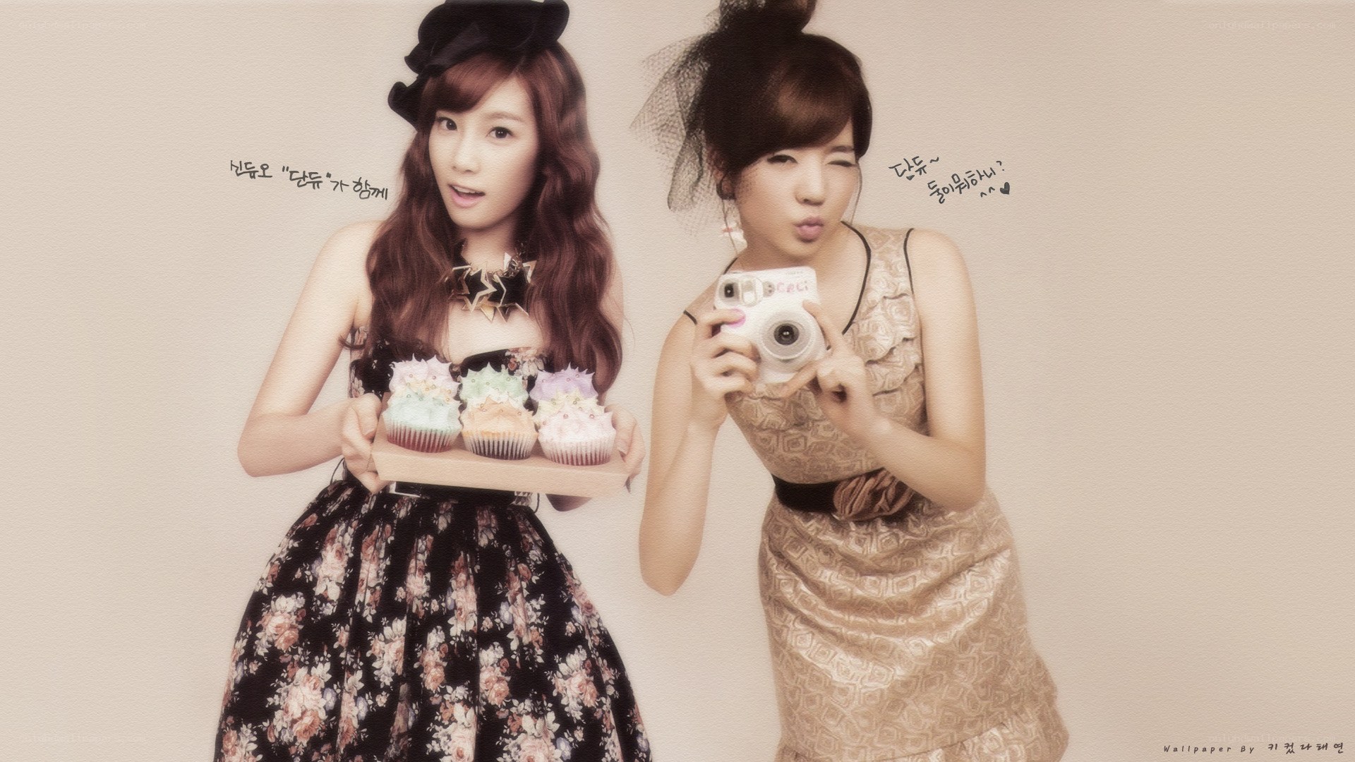 Two women with cupcakes and camera