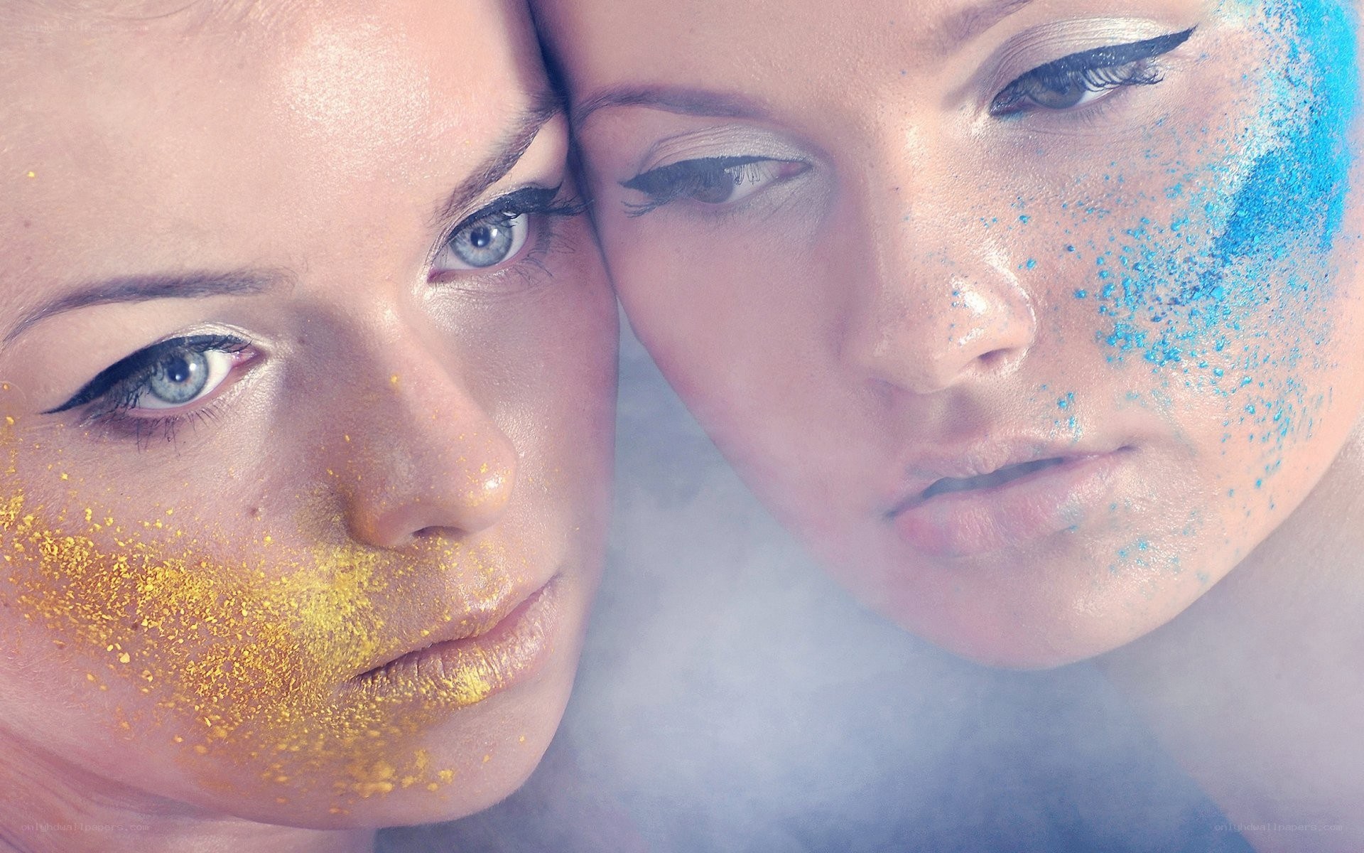 Two women with glitter makeup