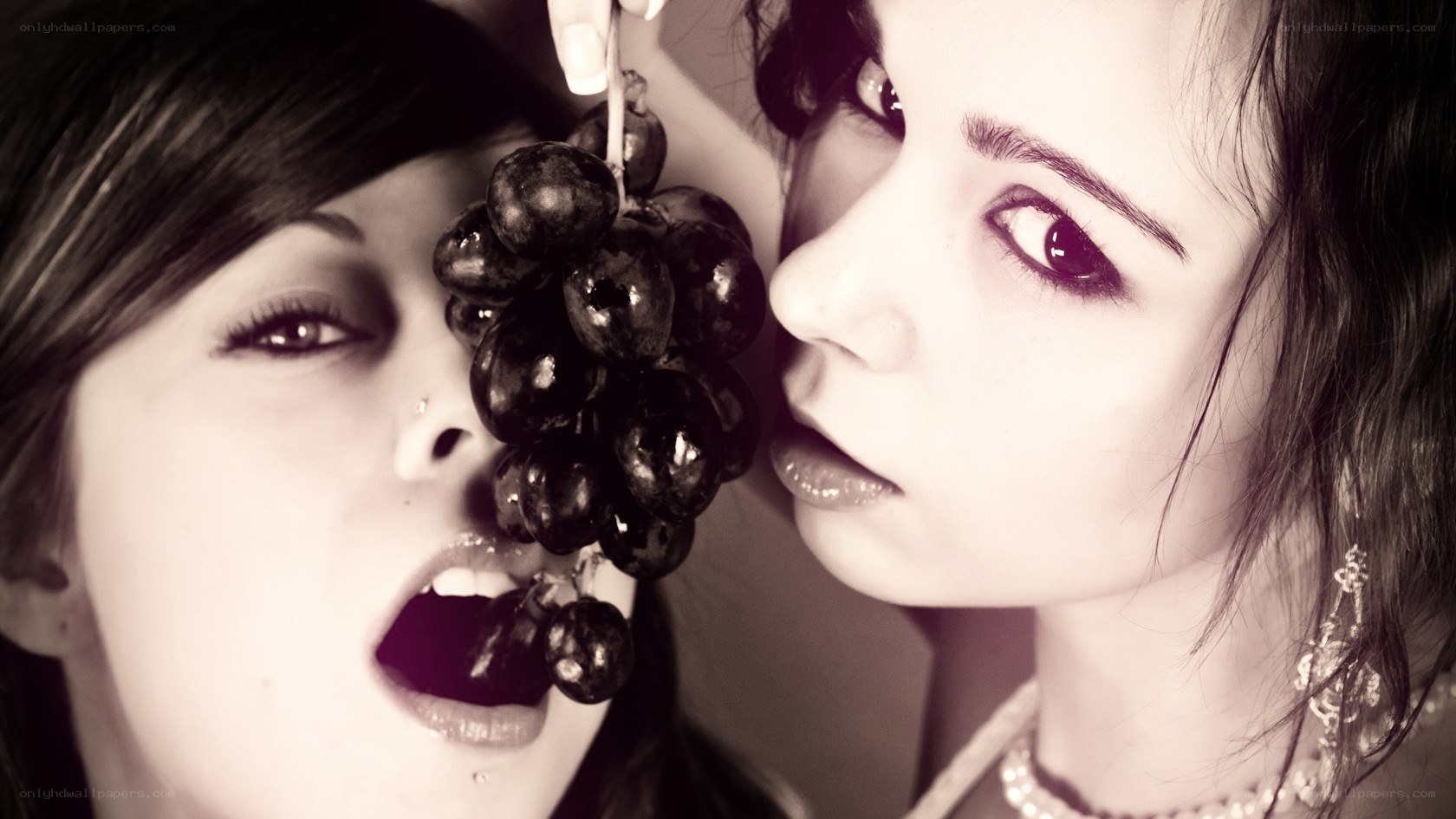 two women with grapes